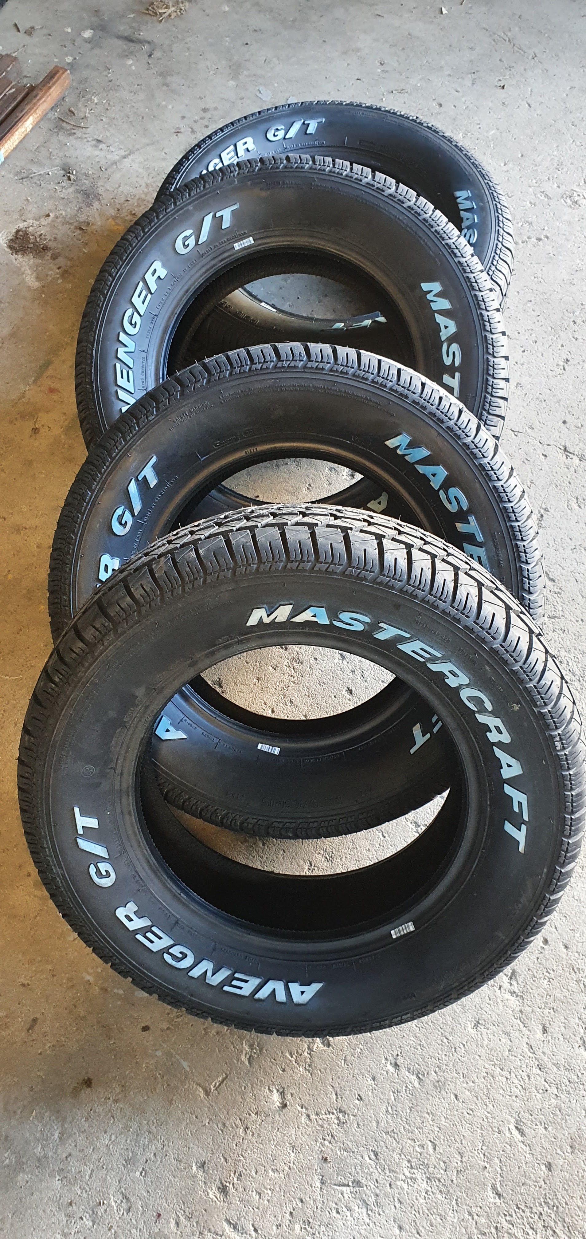 A set of Mastercraft Avenger G/T raised white letter tyres on the workshop floor
