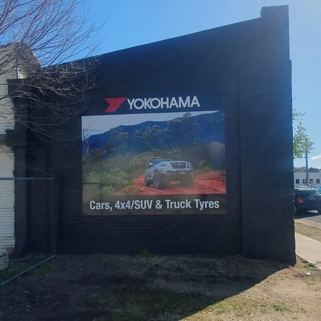 The painted Yokohama wall sign reading cars, 4x4 SUV and truck tyres